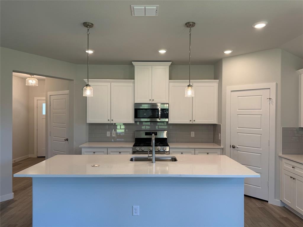 605 Finlee Way Tioga, TX 76271 - Photo 14 of 22 a kitchen with kitchen island a counter top space appliances and cabinets