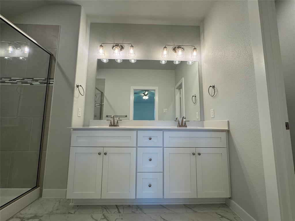 605 Finlee Way Tioga, TX 76271 - Photo 20 of 22 a bathroom with a double vanity sink and a mirror