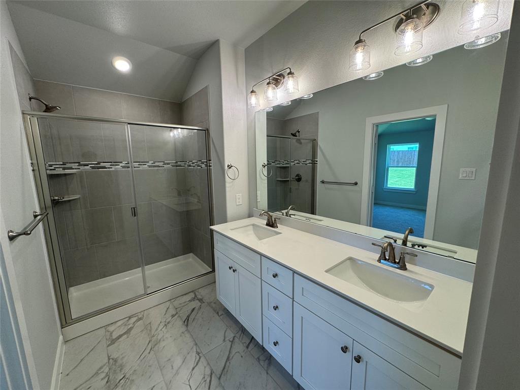 605 Finlee Way Tioga, TX 76271 - Photo 21 of 22 a bathroom with a shower sink double and mirror