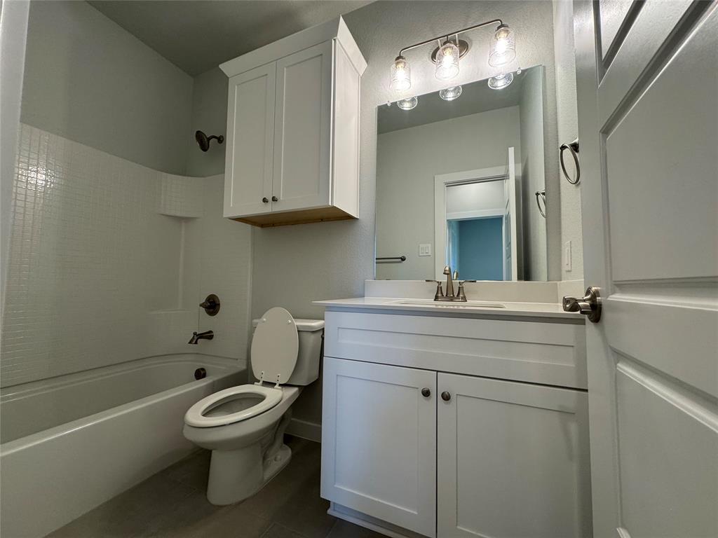 605 Finlee Way Tioga, TX 76271 - Photo 8 of 22 a bathroom with a toilet sink and mirror