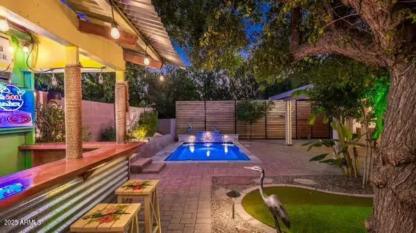 a view of a chairs and table in backyard