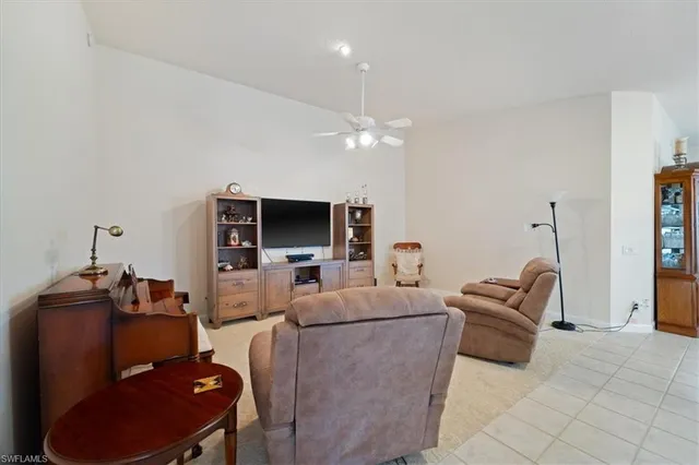 a living room with furniture a rug and a chandelier
