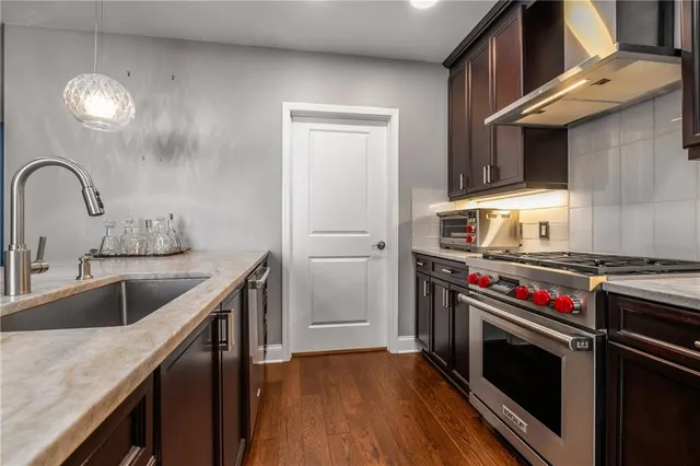 a kitchen with stainless steel appliances granite countertop a stove and a sink