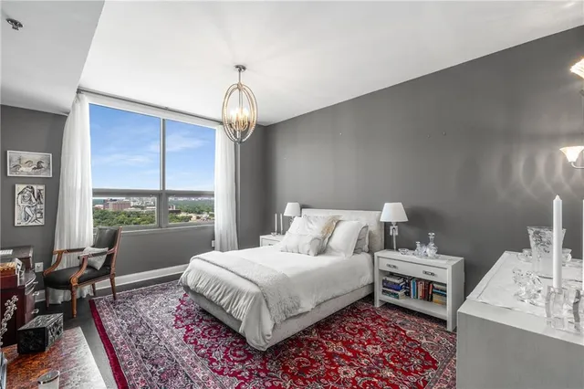 a bedroom with a bed wooden floor and window