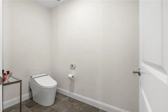 a white toilet sitting next to a white tub
