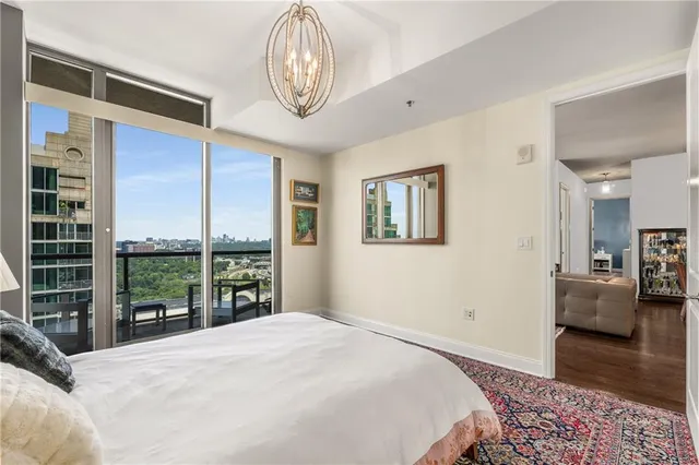 a bedroom with a large bed and a large window