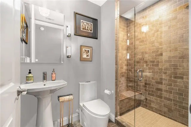 a bathroom with a sink toilet and shower