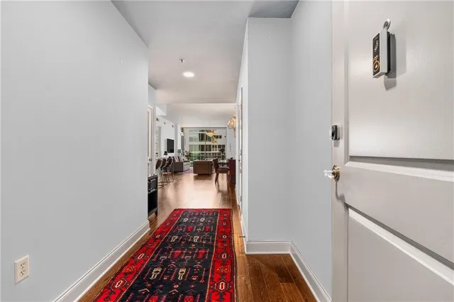 a hallway with wooden floor and furniture