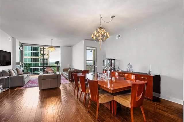 a view of a dining room with furniture wooden floor and chandelier