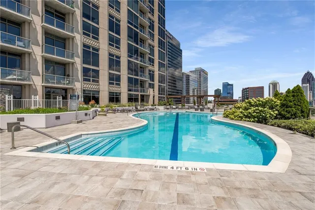 a swimming pool with outdoor view and tall buildings