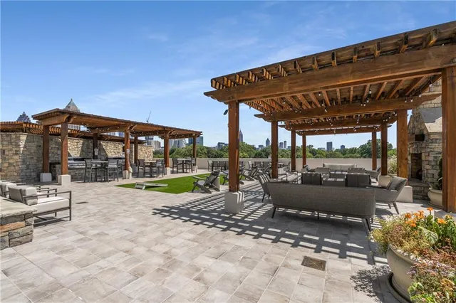 a view of a patio with a table and chairs under an umbrella with a patio