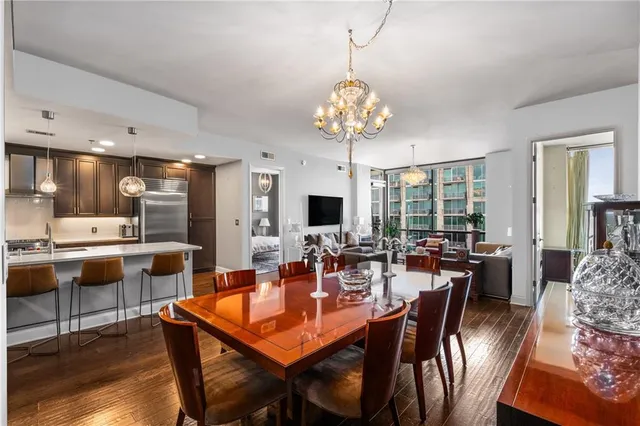 a view of a dining room with furniture a chandelier and wooden floor