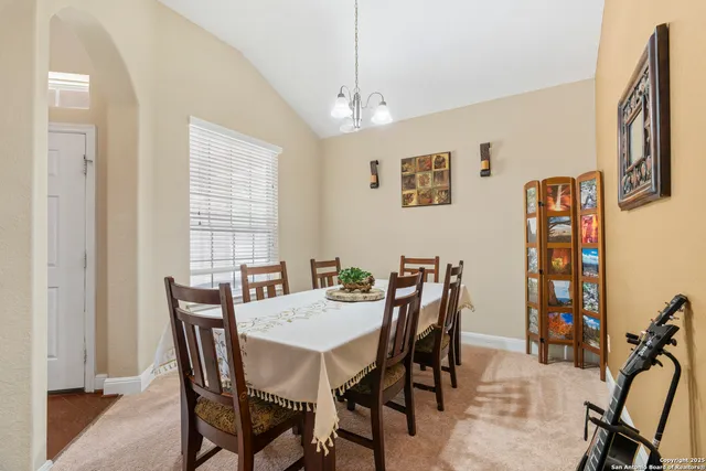 a view of a dining room with furniture and window