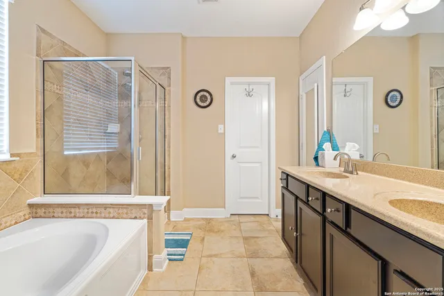 a bathroom with a tub sink and a mirror