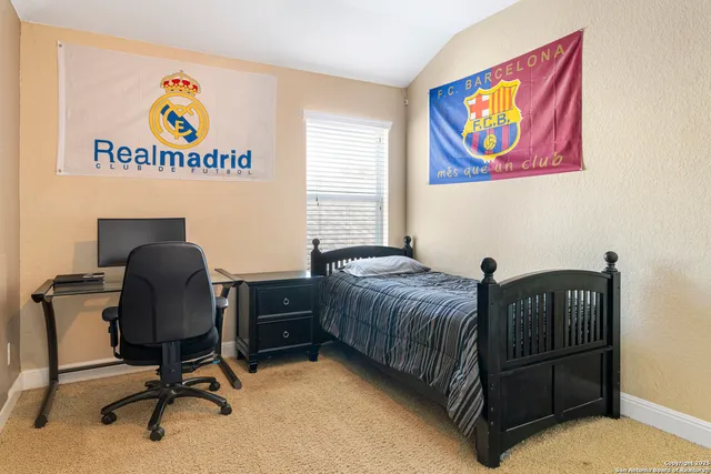 a bedroom with a bed and a desk