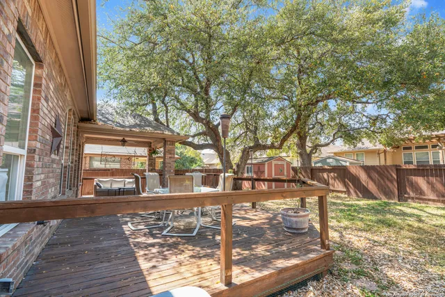 a view of a yard with wooden fence