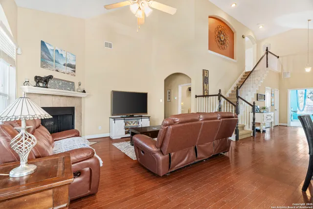 a living room with furniture a flat screen tv and a fireplace