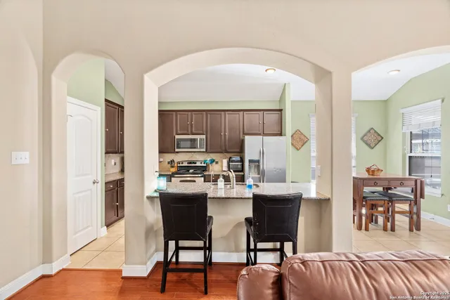 a dining room with furniture and wooden floor