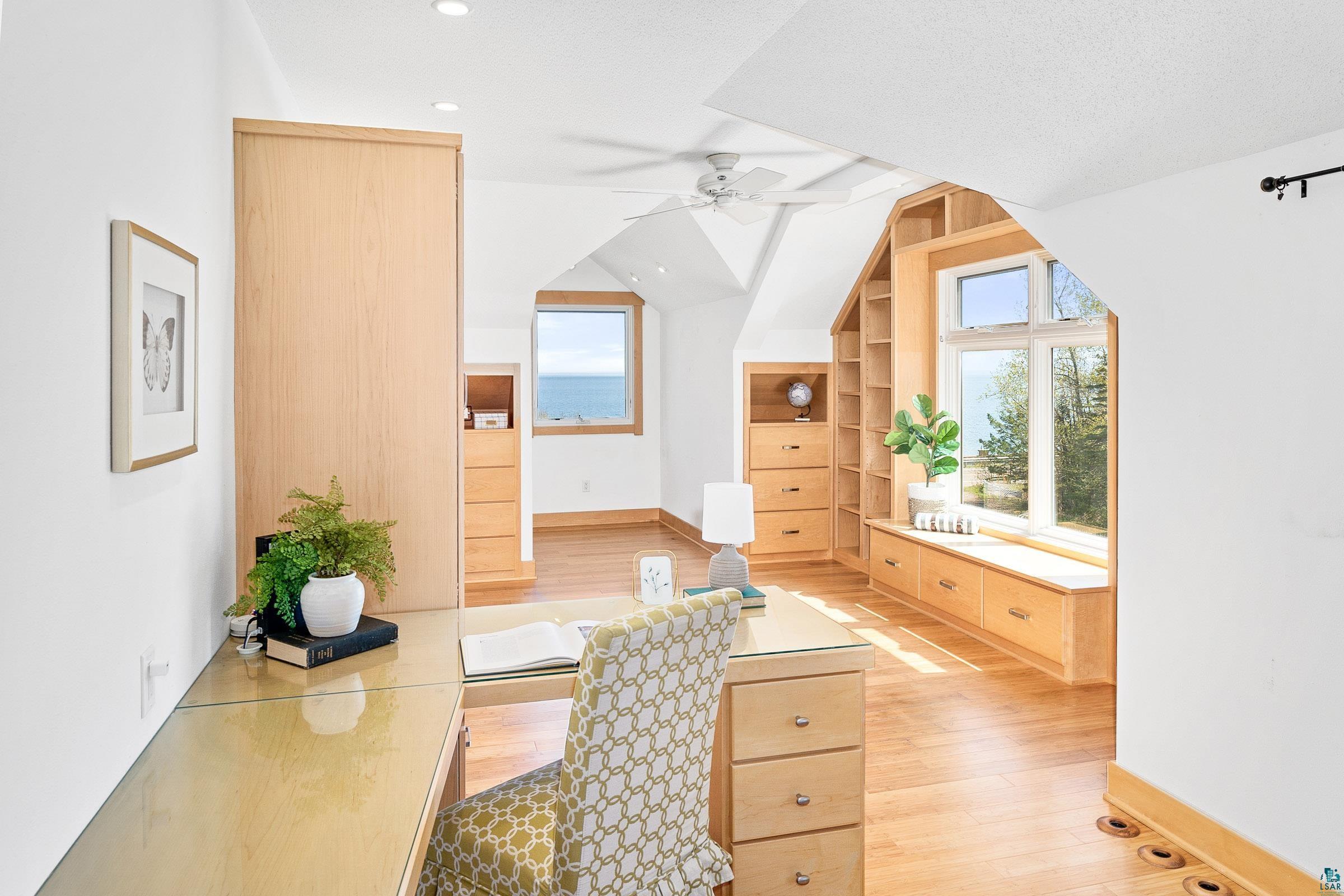 5163 Greenwood Road Duluth, MN 55804 - Photo 27 of 47 Light-filled room featuring built-in blonde wood cabinetry, shelving, and a window seat with storage