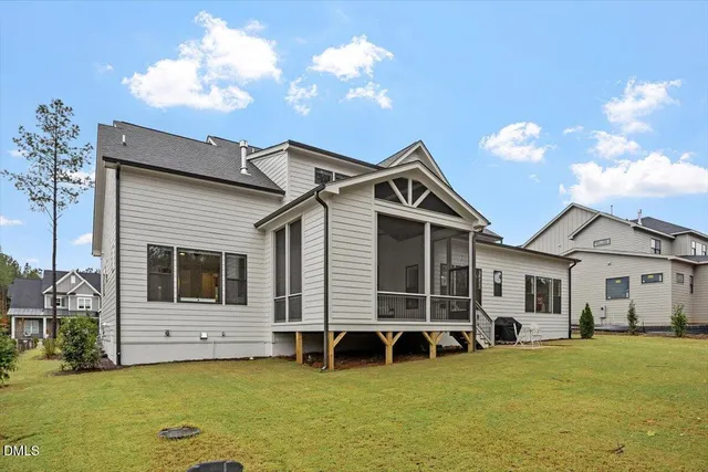a front view of a house with garden fire pit and outdoor seating