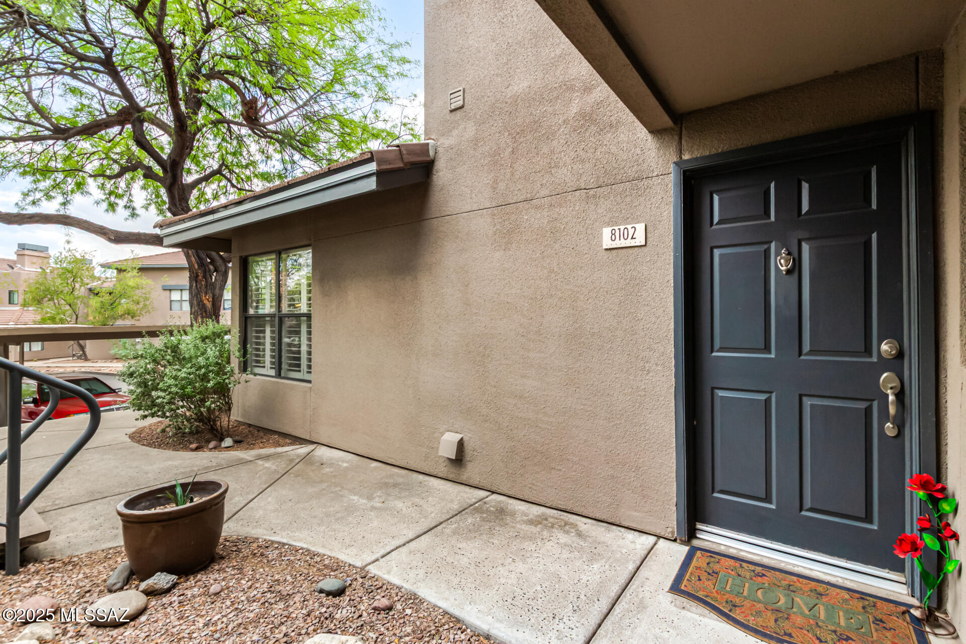 5855 North Kolb Road, Unit 8102 Tucson, AZ 85750 - Photo 4 of 28 a backyard of a house with potted plants and a bench