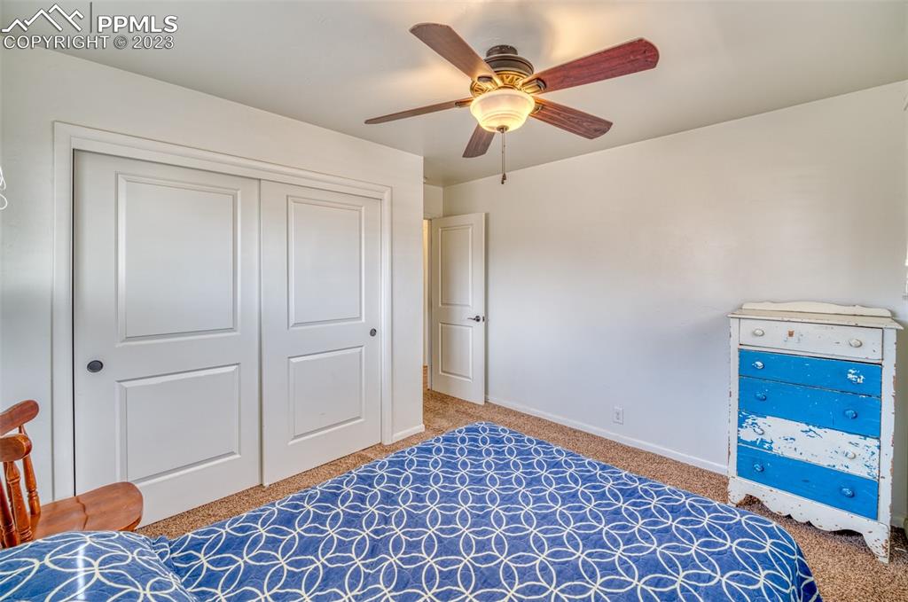 45 Duke Street Pueblo, CO 81005 - Photo 19 of 49 a bedroom with a bed and a lamp on the dresser