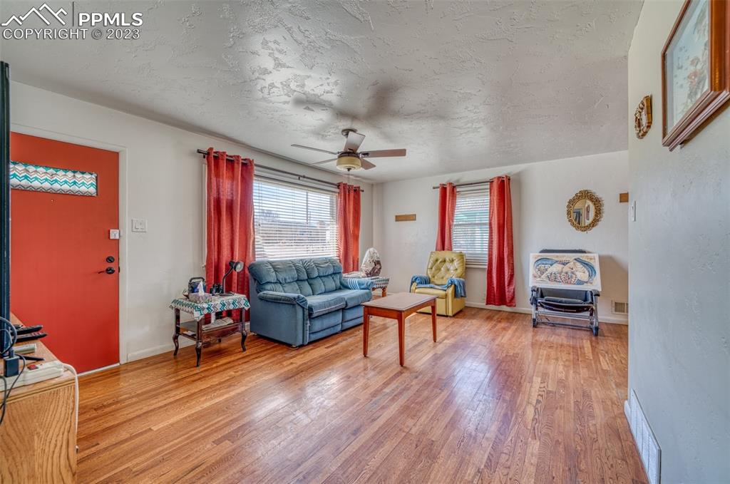 45 Duke Street Pueblo, CO 81005 - Photo 3 of 49 a living room with furniture and a wooden floor