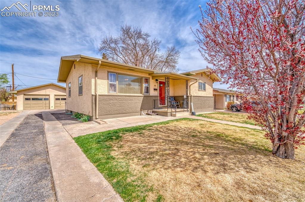 45 Duke Street Pueblo, CO 81005 - Photo 42 of 49 a front view of a house with a yard and garage