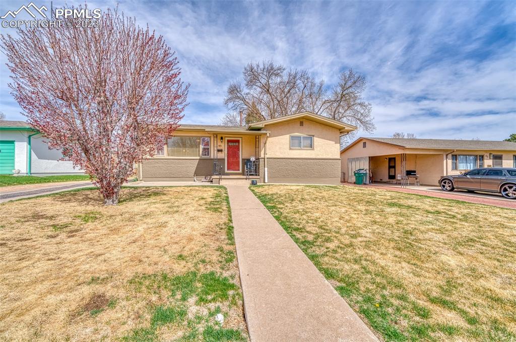 45 Duke Street Pueblo, CO 81005 - Photo 44 of 49 a front view of a house with a yard covered with snow