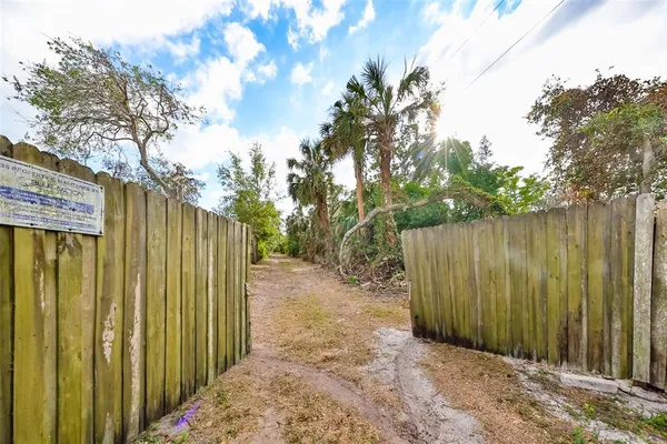 a view of a pathway of a wooden fence