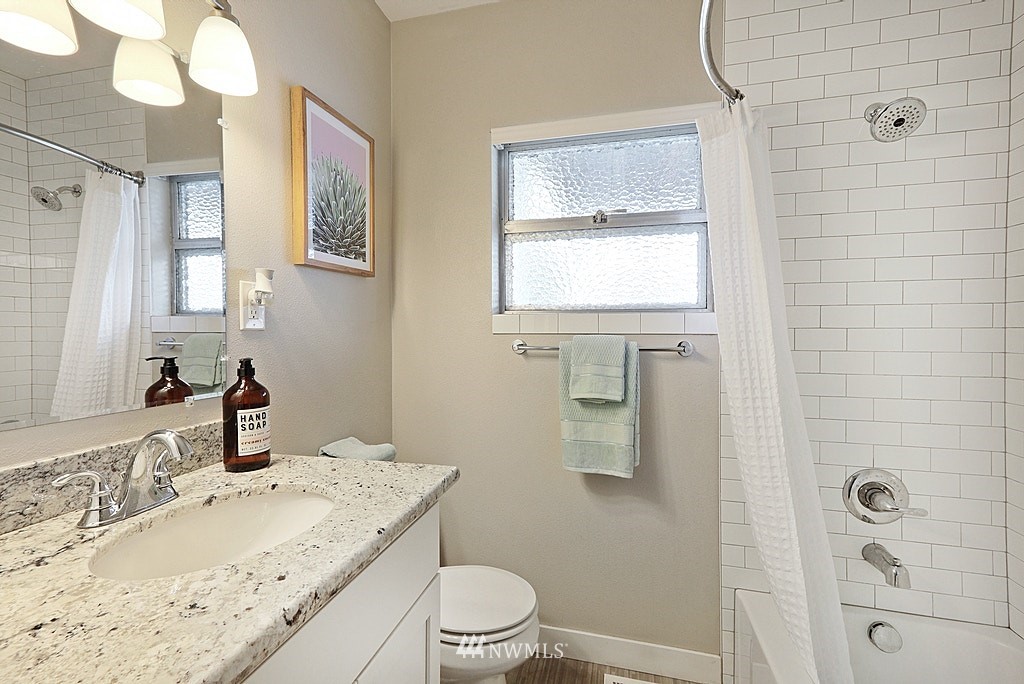 6601 Highland Drive Everett, WA 98203 - Photo 12 of 32 a bathroom with a granite countertop sink toilet and shower