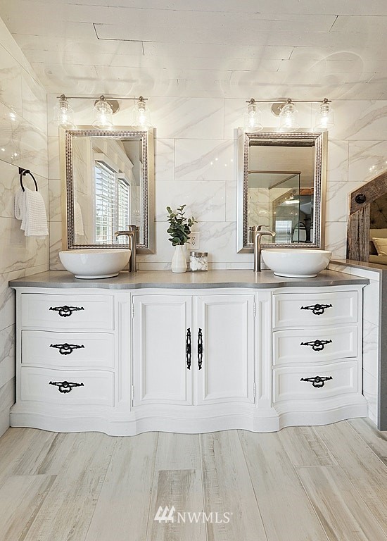 6601 Highland Drive Everett, WA 98203 - Photo 18 of 32 a bathroom with a sink a vanity a mirror and a glass door shower
