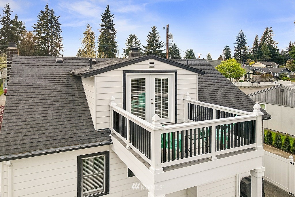 6601 Highland Drive Everett, WA 98203 - Photo 20 of 32 a view of a white house with large windows and wooden fence