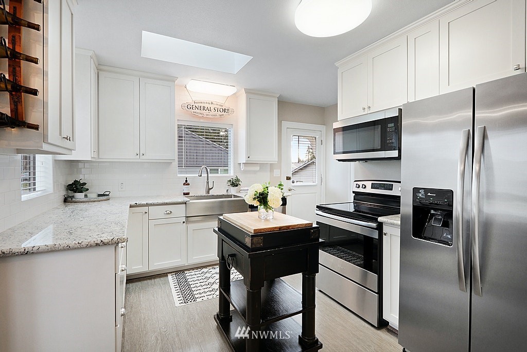 6601 Highland Drive Everett, WA 98203 - Photo 7 of 32 a kitchen with a sink appliances and cabinets