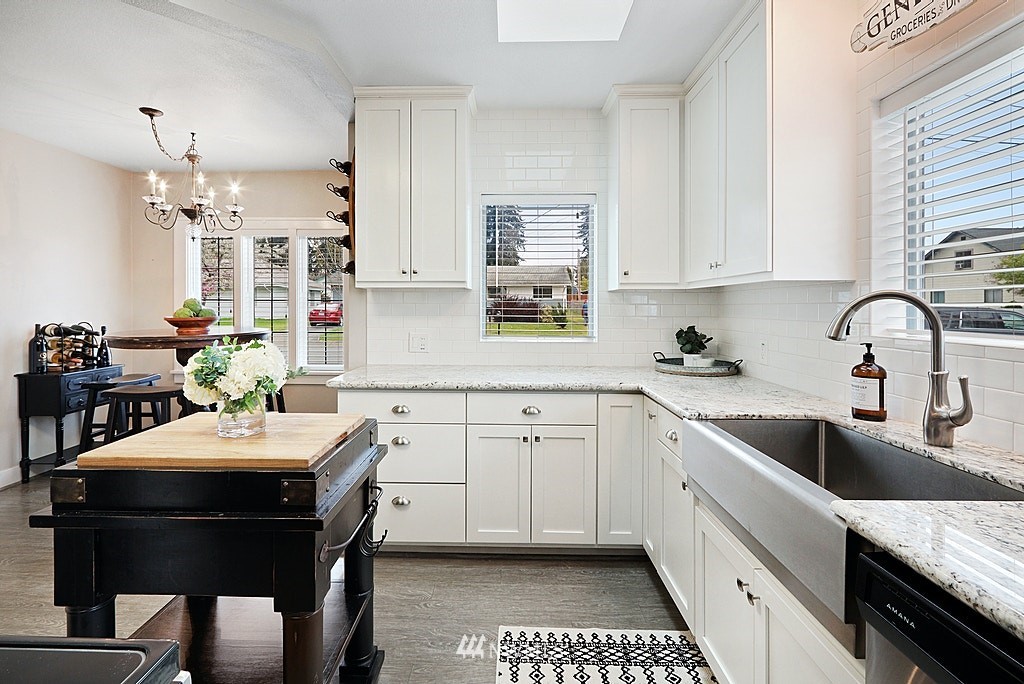 6601 Highland Drive Everett, WA 98203 - Photo 8 of 32 a kitchen with a sink stove and white cabinets