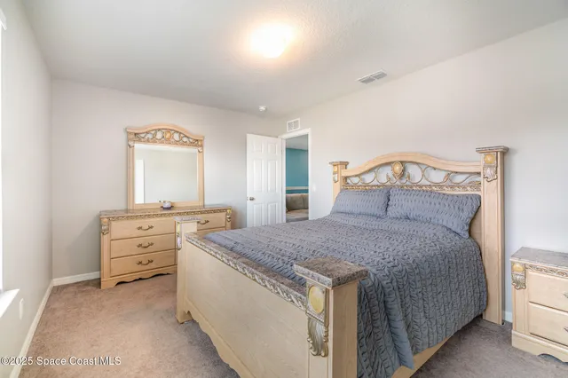 a bedroom with a bed and cabinets