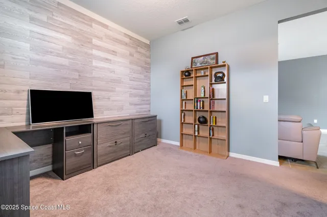 a large bedroom with a bed and a television in it