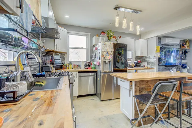 a kitchen that has a lot of cabinets in it and appliances