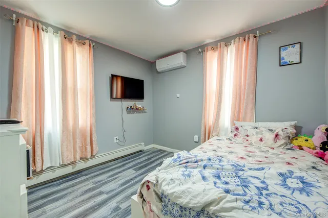 a bedroom with a bed and flat screen tv