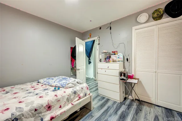 a bedroom with a bed and a dresser