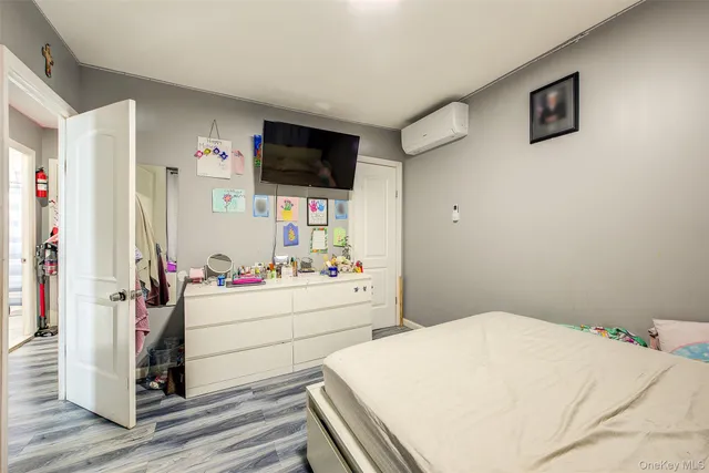 a room with a bed and flat screen tv