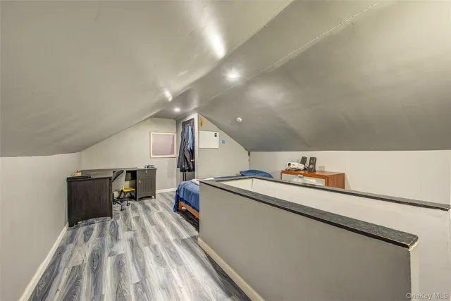 a bedroom with a bed and a large mirror