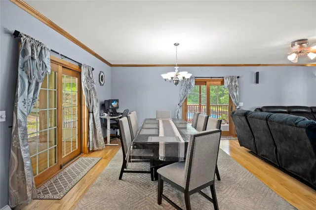 a view of a dining room with furniture and a window