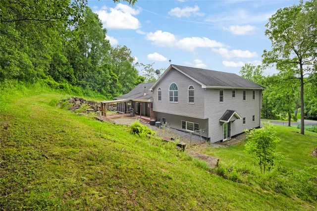 a front view of house with yard and green space