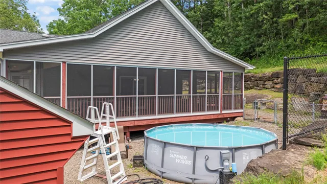 a view of a house with backyard and sitting area