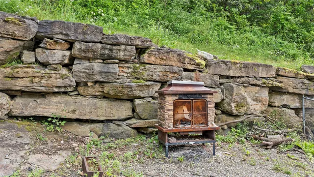 a view of a chairs and table in backyard