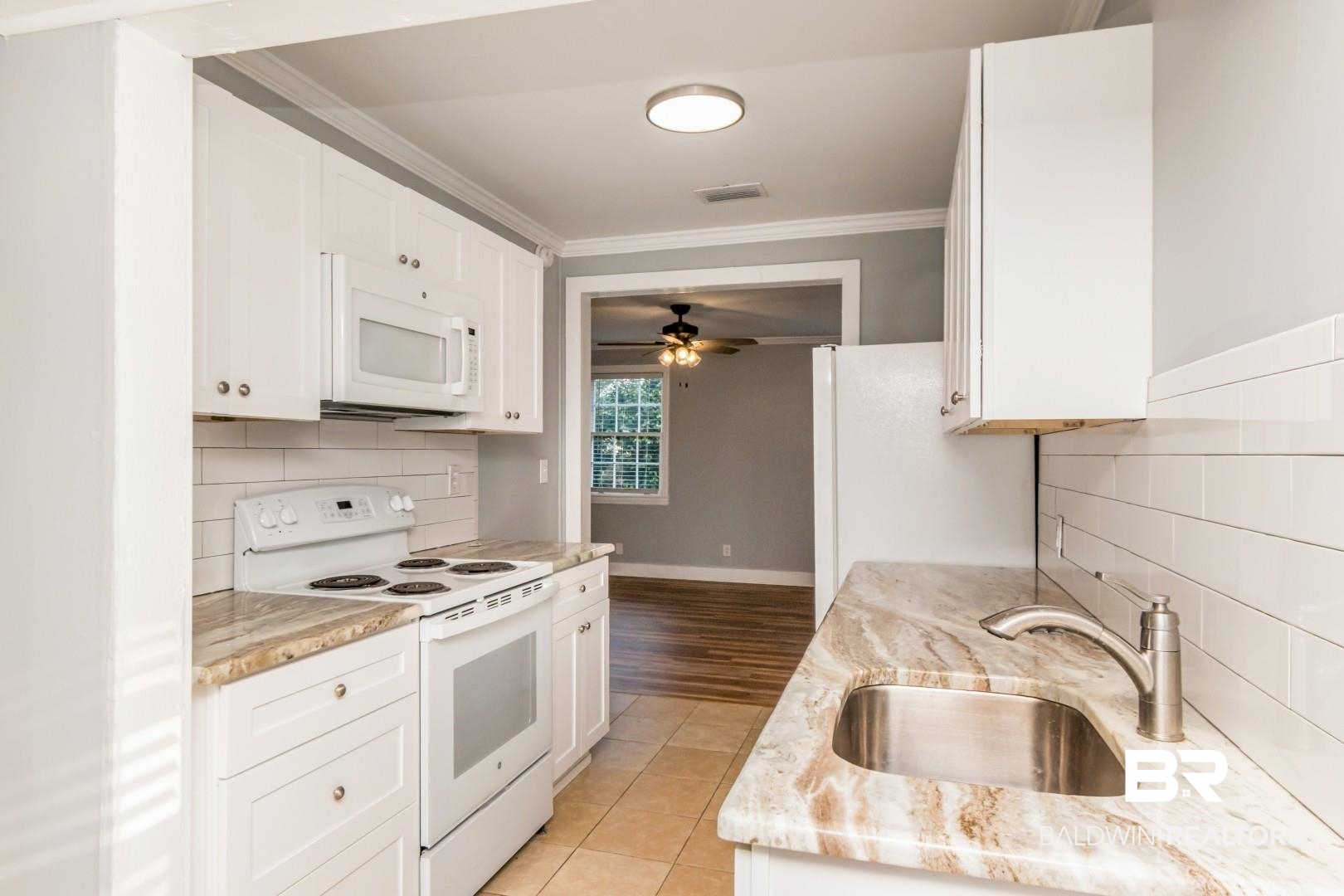 263 Border Drive East Mobile, AL 36608 - Photo 12 of 27 Kitchen featuring white cabinetry, light-toned stone countertops, and a subway tile backsplash