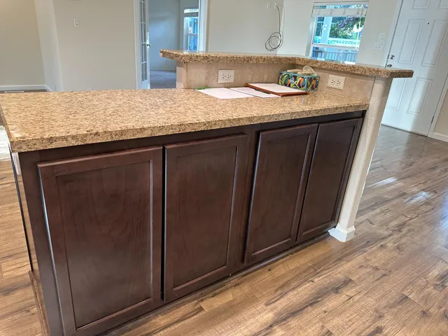 a large kitchen with stainless steel appliances granite countertop a stove a sink and a refrigerator