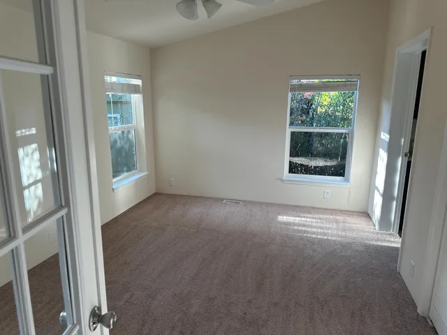 en empty room with windows and entrance