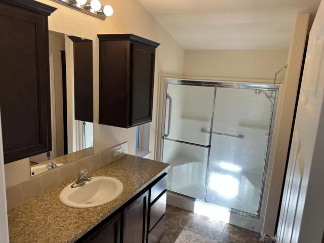 a backyard of a house with table and chairs